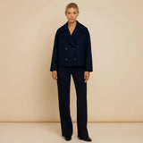 Yemelia navy blue cropped double-breasted jacket with wide lapels and decorative buttons.