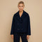 Yemelia navy blue cropped double-breasted jacket with wide lapels and decorative buttons.