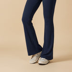 Yemelia navy blue sleeveless sculpting flared leg jumpsuit made from smooth, stretchy fabric.