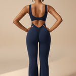 Yemelia navy blue sleeveless sculpting jumpsuit with ruched back detail and flared legs.