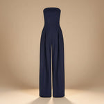 Yemelia navy blue strapless wide leg jumpsuit with tailored fit and side pockets. Elegant evening wear.
