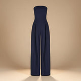 Yemelia navy blue strapless wide leg jumpsuit with tailored fit and side pockets. Elegant evening wear.