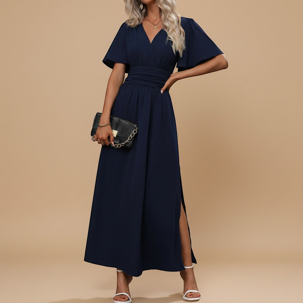 Yemelia navy blue V-neck flutter sleeve maxi dress with defined waist and side slit. Elegant, flowing silhouette for events.