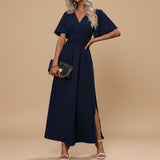 Yemelia navy blue V-neck flutter sleeve maxi dress with defined waist and side slit. Elegant, flowing silhouette for events.