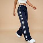 Yemelia navy blue high waist wide leg track pants with white side stripe detail and elastic waistband.