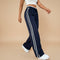 Yemelia navy blue high waist wide leg track pants with white side stripe detail and elastic waistband.