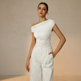 Yemelia off-white ruched one-shoulder top with asymmetrical neckline and stretch fabric.
