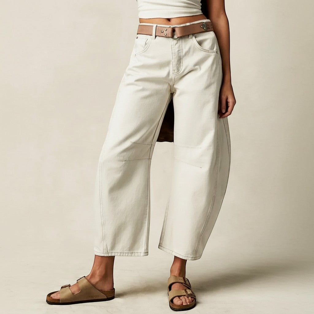 Yemelia off-white denim wide leg jeans with relaxed fit and contrast stitching. Mid-rise waist, five-pocket styling.