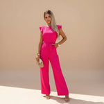 Yemelia bright pink flutter sleeve wide leg jumpsuit with adjustable waist tie and pockets.