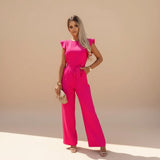 Yemelia bright pink flutter sleeve wide leg jumpsuit with adjustable waist tie and pockets.