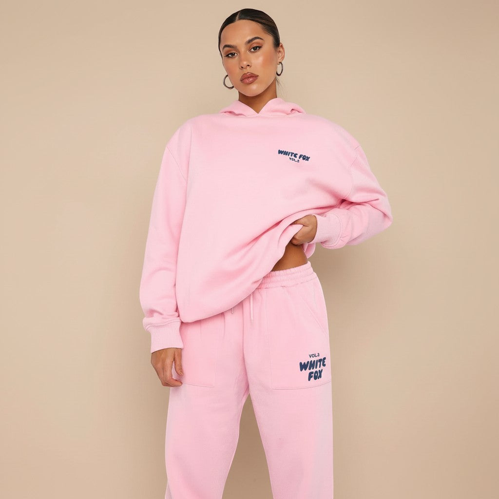 Yemelia pink relaxed fit hoodie and jogger set with subtle graphic text accent. Soft cotton blend for ultimate comfort.