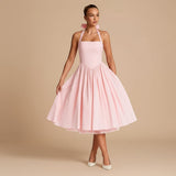 Yemelia light pink halter neck fit and flare midi dress with a full skirt and bow detail.