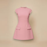 Yemelia pink structured mini dress with high neck, cap sleeves, flared skirt, and flap pockets.
