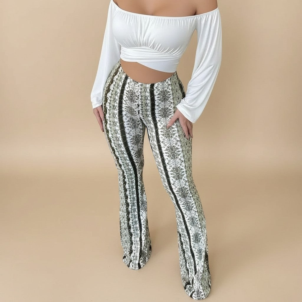 Yemelia high waist flared pants with a white, black, and green abstract print. Stretch fit, pull-on style.