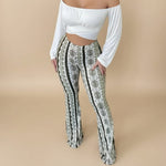 Yemelia high waist flared pants with a white, black, and green abstract print. Stretch fit, pull-on style.