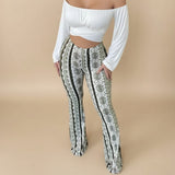 Yemelia high waist flared pants with a white, black, and green abstract print. Stretch fit, pull-on style.