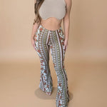 Yemelia high waist flared pants with all-over floral and geometric print, made from stretch fabric.