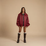 Yemelia red faux leather zip front bomber jacket with ribbed trim and structured silhouette.