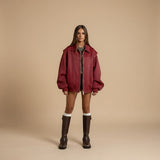 Yemelia red faux leather zip front bomber jacket with ribbed trim and structured silhouette.