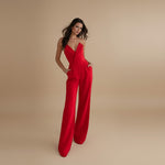 Yemelia red tailored jumpsuit with deep V halter neck and wide leg trousers. Ideal for formal events.