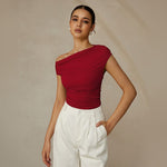 Yemelia red one shoulder ruched fitted top with asymmetrical neckline and stretch fabric.