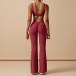 Yemelia sleeveless sculpting flared leg jumpsuit in deep red with ruched back detail and a low scoop back.