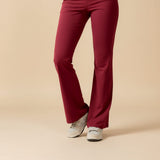 Yemelia sleeveless sculpting flared leg jumpsuit in deep red, made from smooth stretch fabric.
