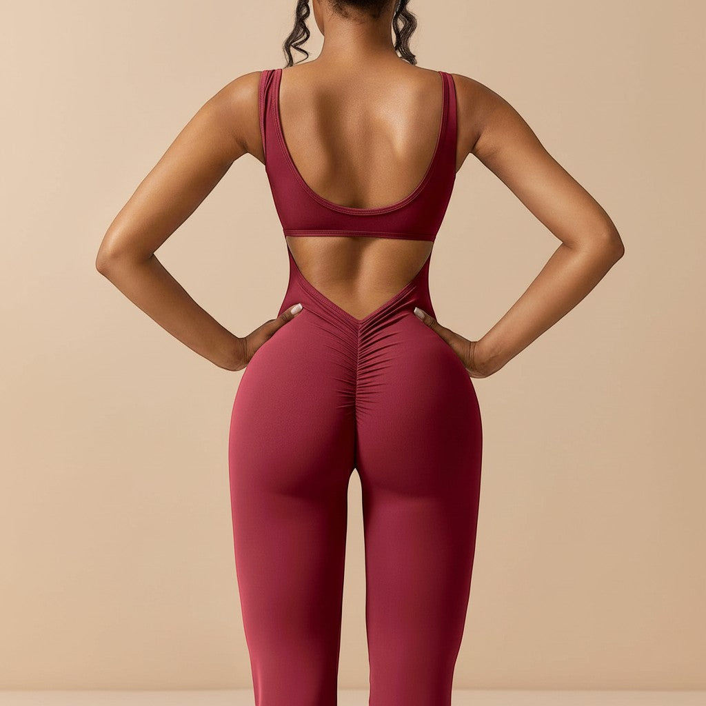 Yemelia sleeveless sculpting jumpsuit in deep red, featuring a V-back cutout and ruched detailing on the seat. Flared leg design.