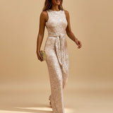 Yemelia sleeveless rose gold sequin wide leg jumpsuit with waist tie, perfect for evening events.