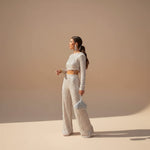 Yemelia silver sequin crop top and wide leg pants evening set with long sleeves and fringe detail.