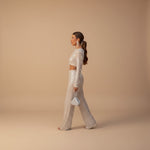 Yemelia silver sequin long sleeve crop top and wide leg pants evening set with fringe detail.