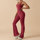 Yemelia sleeveless sculpting flared leg jumpsuit in deep red. Smooth, stretch fabric contours the body for a flattering fit.
