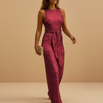 Yemelia sleeveless deep pink sequin wide leg jumpsuit with waist tie, perfect for evening events.