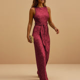 Yemelia sleeveless deep pink sequin wide leg jumpsuit with waist tie, perfect for evening events.