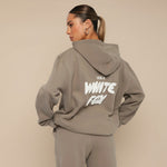 Yemelia taupe relaxed fit hoodie and jogger set with graphic text accent on back. Soft fabric, elastic waistband.