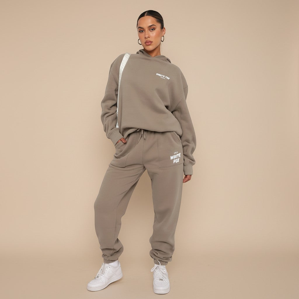 Yemelia taupe relaxed fit hoodie and jogger set with graphic accent, soft fabric, elastic waistband.