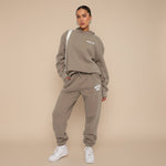Yemelia taupe relaxed fit hoodie and jogger set with graphic accent, soft fabric, elastic waistband.