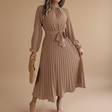Yemelia taupe long sleeve pleated midi dress with high neck and waist tie. Elegant, flowing silhouette.