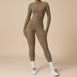 Yemelia taupe long sleeve zip front sculpting one piece jumpsuit with a high neckline and full-length fit.