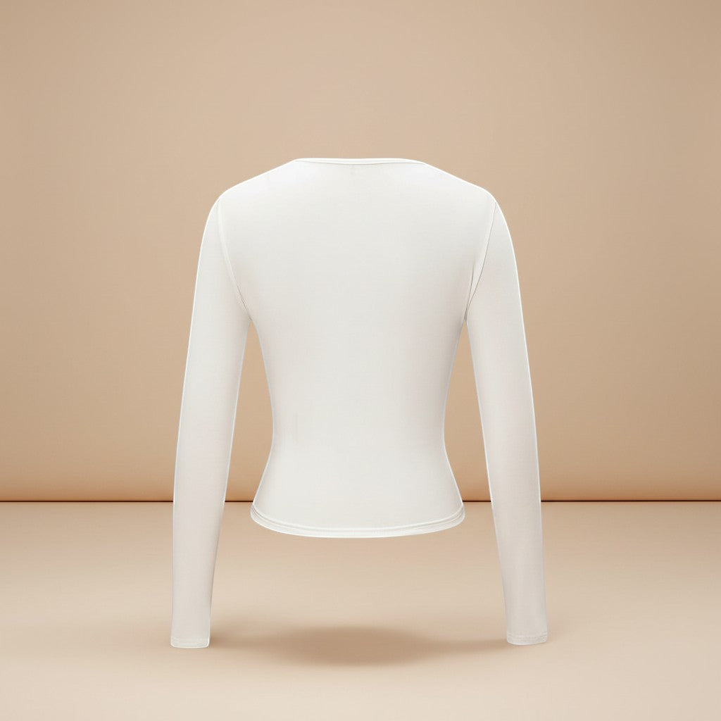 Yemelia white long sleeve fitted crop top with thumbhole cuffs, made from soft stretchy fabric.