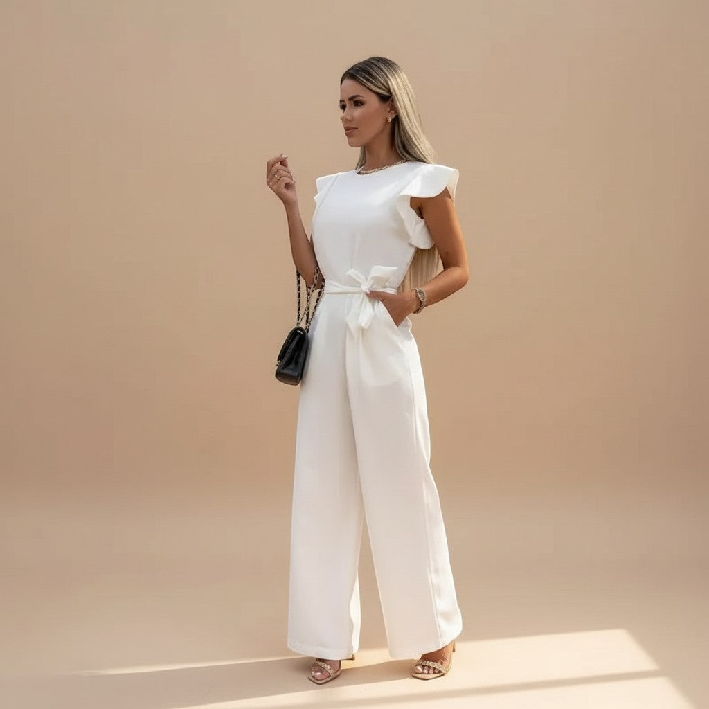 Yemelia white flutter sleeve wide leg jumpsuit with adjustable waist tie and pockets. Elegant formal wear.