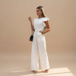 Yemelia white flutter sleeve wide leg jumpsuit with adjustable waist tie and pockets. Elegant formal wear.