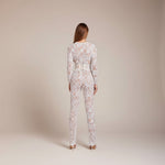 Yemelia white lace sequin jumpsuit with long sleeves, structured lace-up waist, and wide legs. Ideal for formal events.
