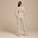 Yemelia white lace sequin jumpsuit with long sleeves, structured waist, and wide legs. Ideal for formal events.