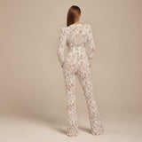 Yemelia white lace sequin jumpsuit with long sleeves, structured waist, and wide legs. Ideal for formal events.