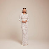 Yemelia white lace sequin jumpsuit with long sleeves, structured waist, and wide legs. Ideal for formal events.
