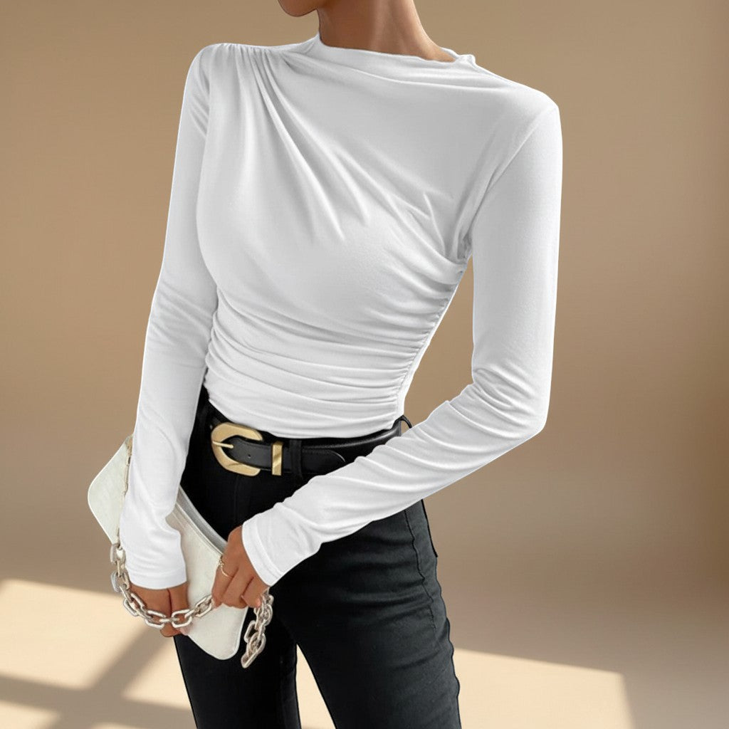 Yemelia white long sleeve fitted top with asymmetrical neckline and ruched detailing, made from stretch fabric.