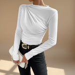 Yemelia white long sleeve fitted top with asymmetrical neckline and ruched detailing, made from stretch fabric.