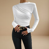 Yemelia white long sleeve fitted top with asymmetrical ruching on the bodice and neckline. Stretch fabric.