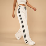 Yemelia white high waist wide leg track pants with black side stripe detail and drawstring waist.